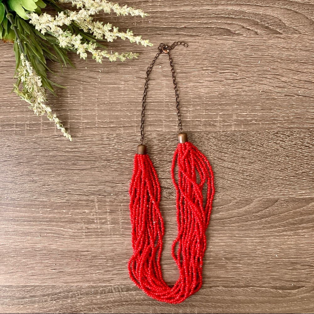 Red beaded necklace with bronze chain